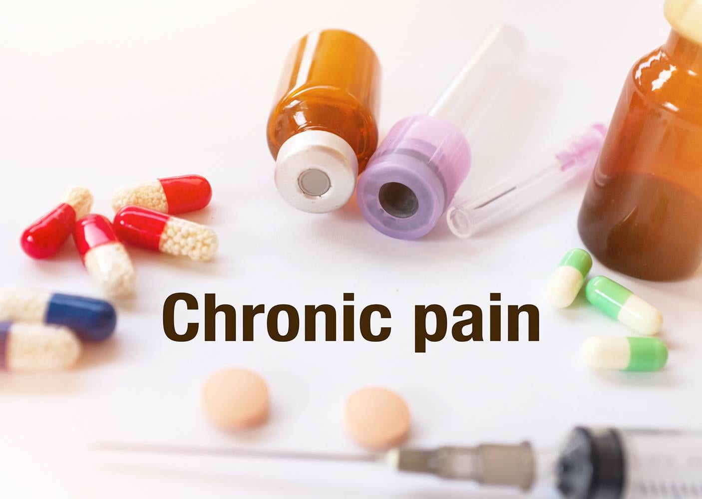 Chronic pain -Diagnosis written on a white piece of paper. Treatment and prevention of disease. Syringe and vaccine with drugs. Medical and Healthcare concept. Selective  focus